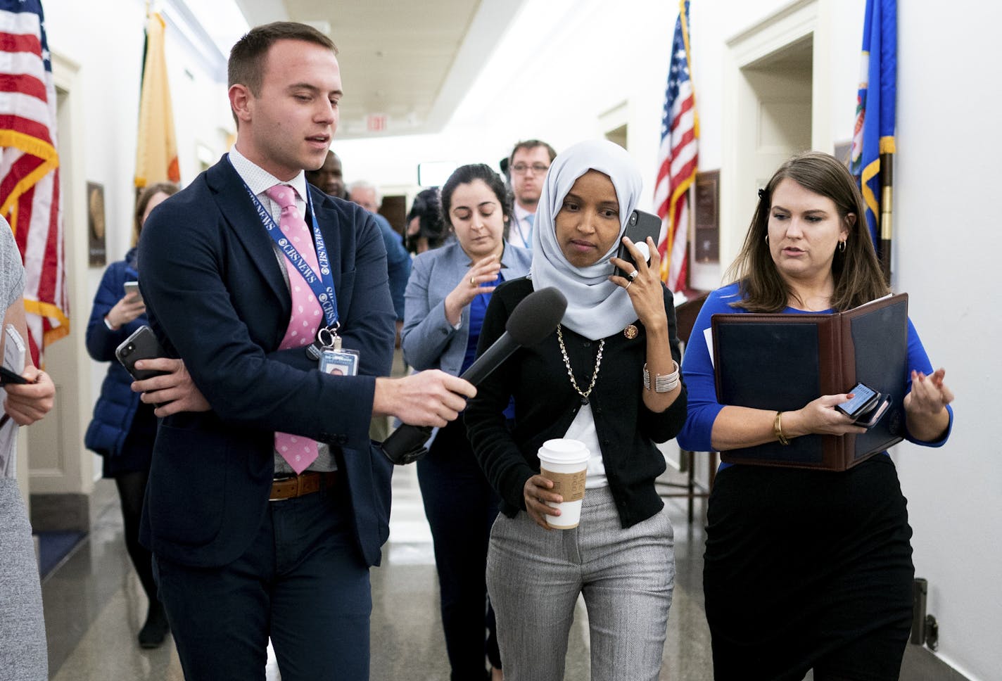 Rep. Ilhan Omar (D-Minn.) walks to a vote surrounded by reporters on Capitol Hill in Washington, March 5, 2019. The decision by House Democratic leaders to put a resolution condemning anti-Semitism on the House floor has touched off a furious debate over whether Omar is being singled out for disparate treatment. (Erin Schaff/The New York Times)