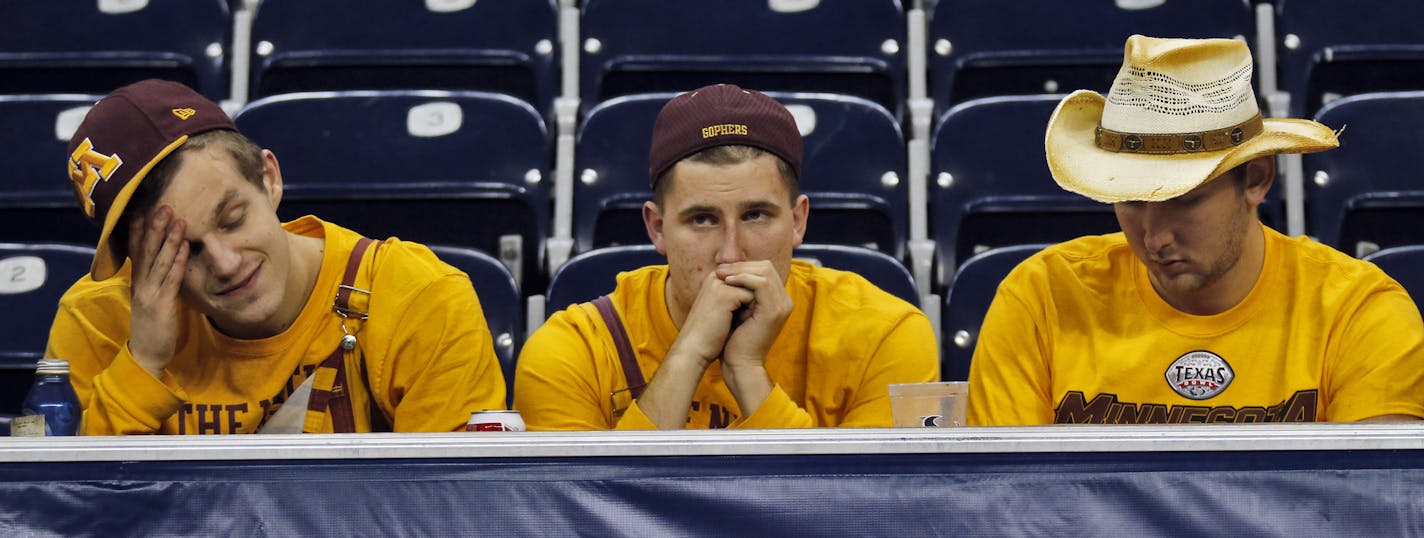 Minnesota Gophers vs. Syracuse Orange in Texas Bowl. Syracuse won 21-17. Three UM students showed their disappointment at the outcome of the game as they stayed in their seats after the final gun. (MARLIN LEVISON/STARTRIBUNE(mlevison@startribune.com)