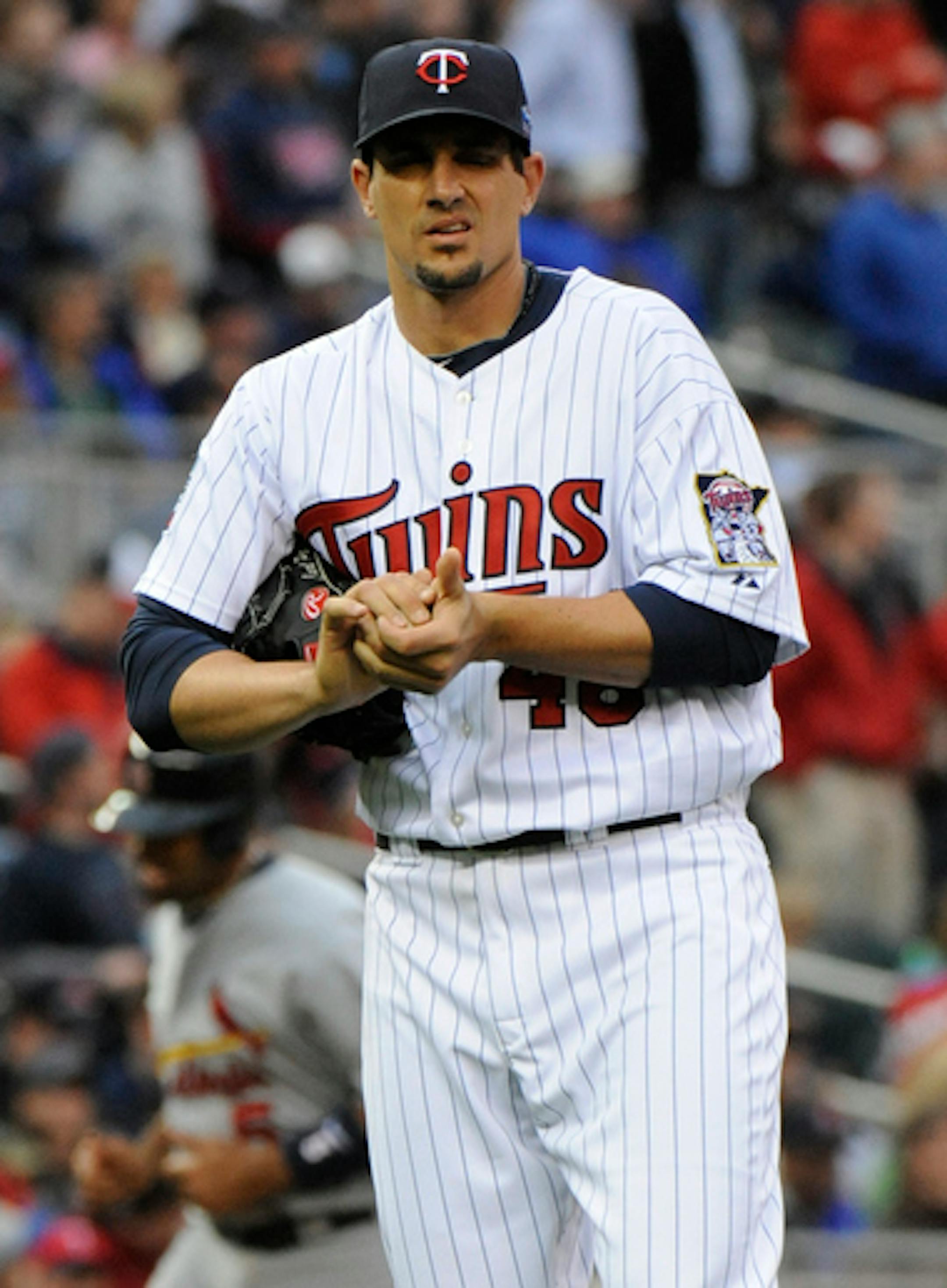 MINNESOTA, MN - APRIL 2: Carl Pavano #48 of Minnesota Twins reacts as Albert Pujols #5 rounds third after Matt Holliday's fourth inning two-run homerun during an exhibition game at Target Field on April 2, 2010 in Minneapolis, Minnesota. (Photo by Hannah Foslien /Getty Images)