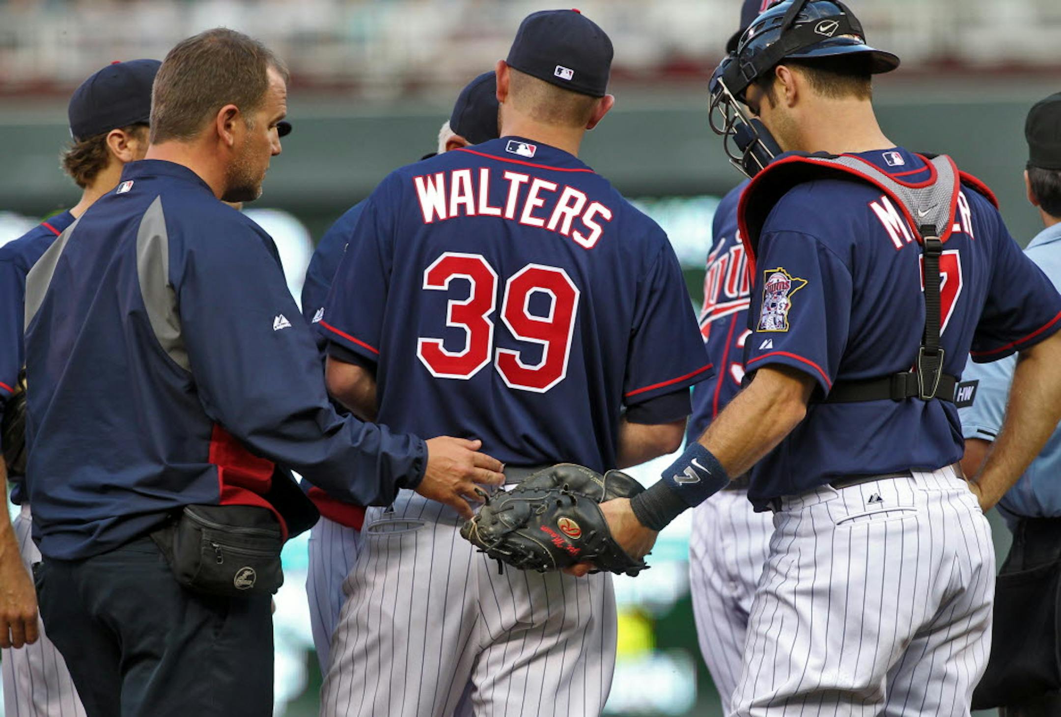 Medical staff and players gathered on the mound around Twins starting pitcher P.J. Walters in the first inning.