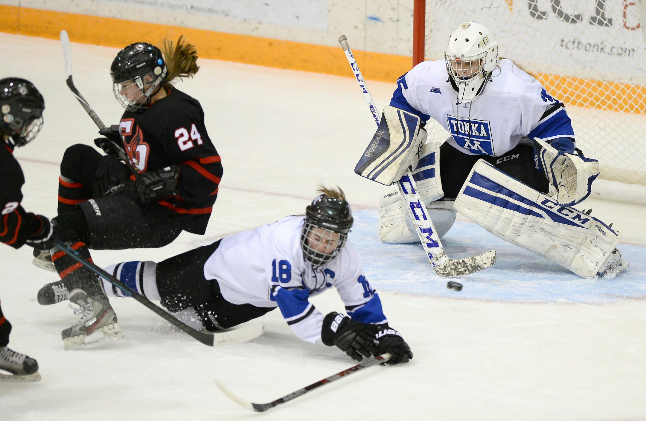 Eden Prairie forward Rachel Werdin (24) and Minnetonka defenseman Katie McMillan (18) collided in front of the net as Minnetonka goalie Tatyana Delaittre (35) blocked a shot by Eden Prairie forward Anna Gravelle (22) in the first period Friday. ] (AARON LAVINSKY/STAR TRIBUNE) aaron.lavinsky@startribune.com Eden Prairie played Minnetonka in the Class 2A, Section 2 Finals on Friday, Feb. 12, 2016 at Ridder Arena in Minneapolis, Minn.