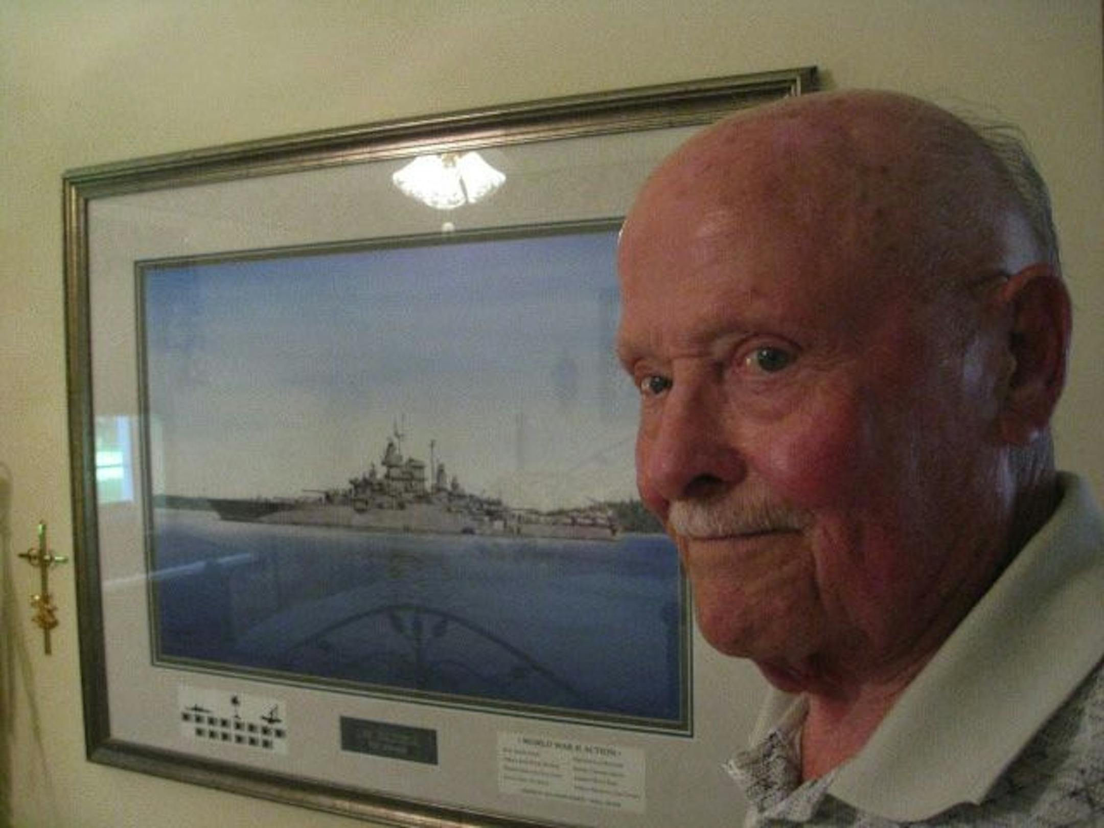 World War II naval veteran Lyle Scribner has a painting of his old battleship hanging in his Oakdale bedroom.