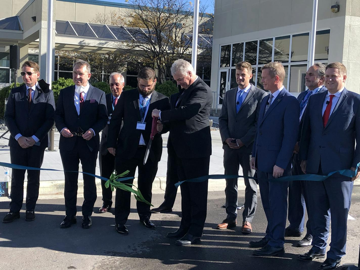 SkyWater Technology CEO Tom Sonderman, with scissors, cuts the ribbon on an expansion of the company's semiconductor factory in Bloomington on Monday. The company, which operates the largest chip plant in Minnesota, built the expansion with funding from the Pentagon.