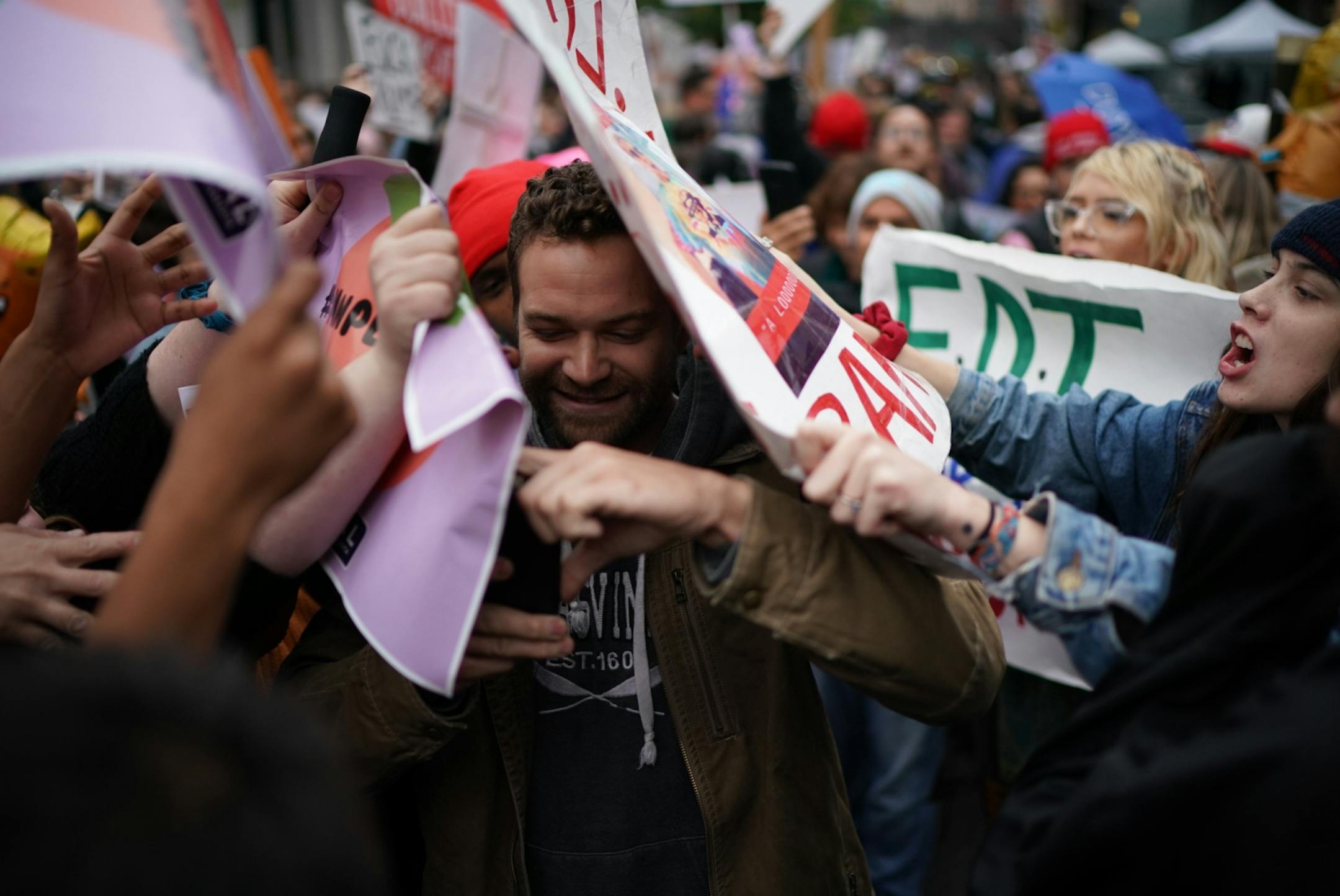 Supporters and protesters against President Trump interact outside Target Center.