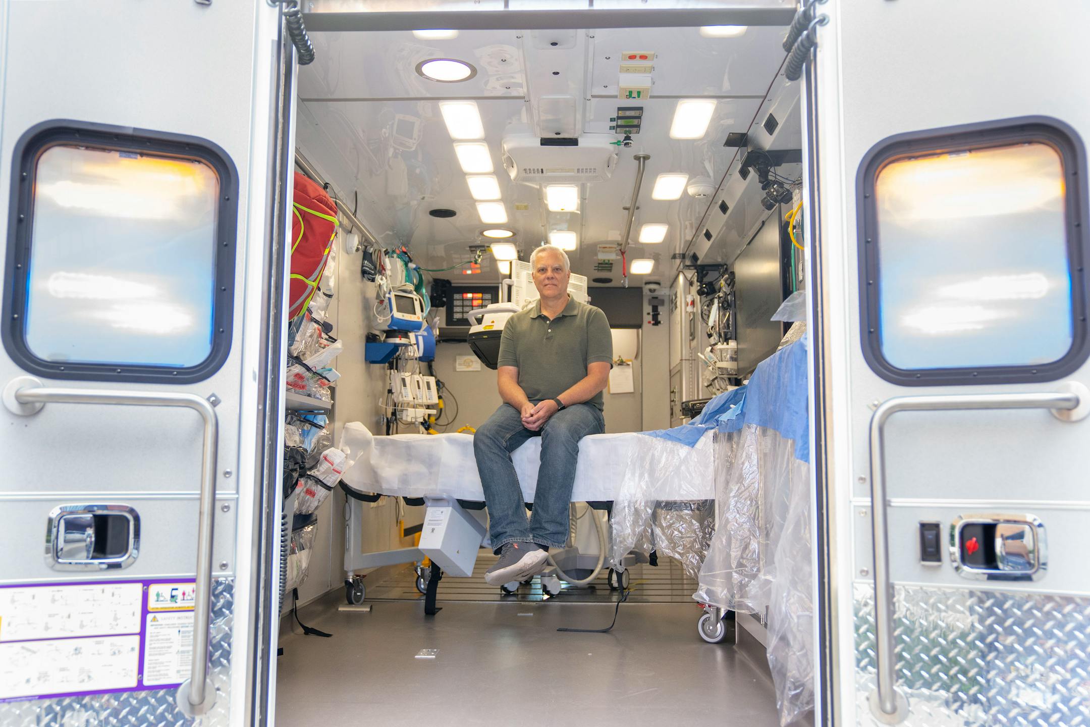 John Sauer, a cardiac arrest survivor, poses for a portrait inside the Minnesota Mobile Resuscitation Consortium, Tuesday, Sep. 19, 2023, at M Health Fairview University of Minnesota Medical Center - East Bank in Minneapolis. Sauer was treated with ECMO in the very same vehicle and credits it with saving his life.