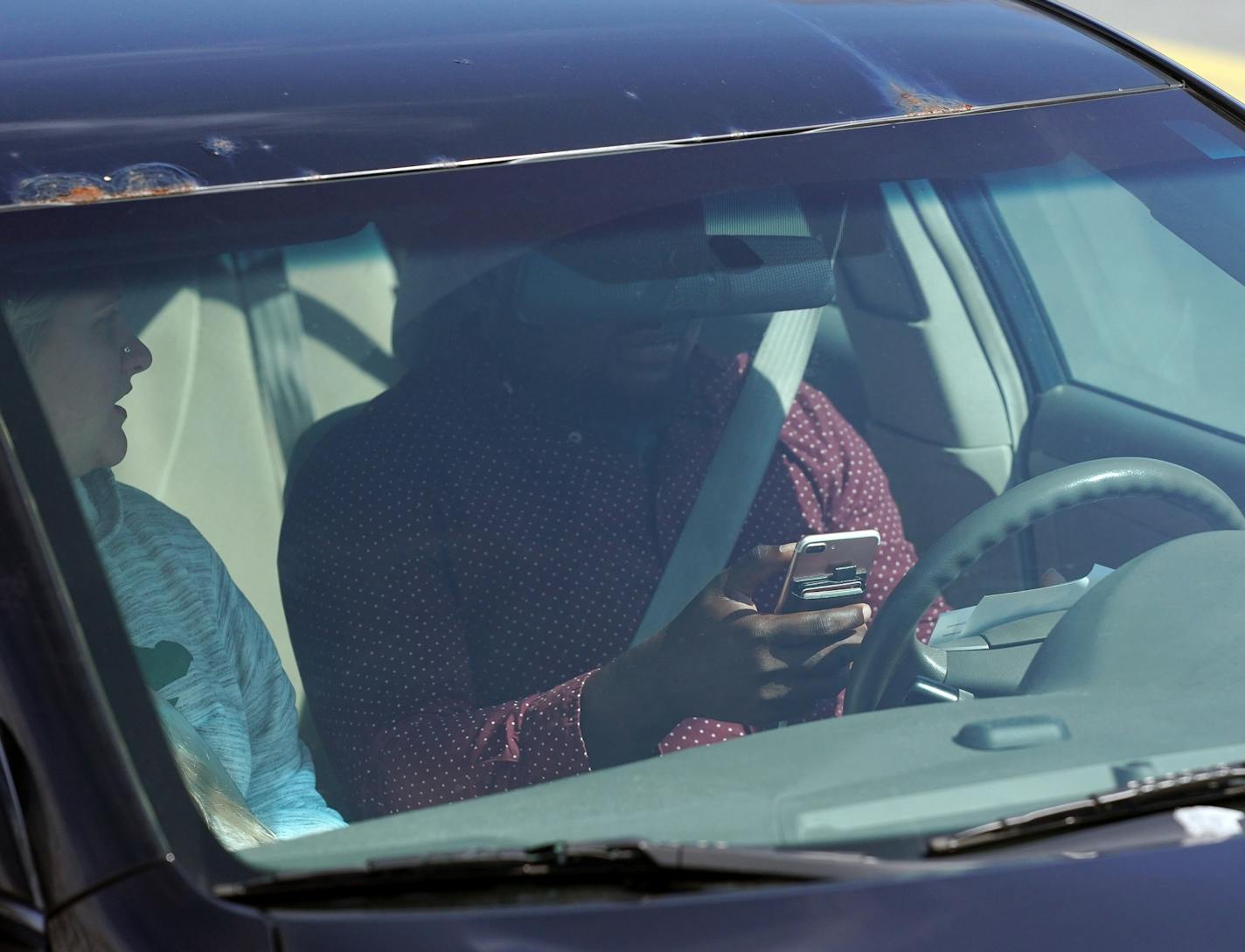 One of the several distracted drivers using cell phones spotted by Eagan police officers during Wednesday's "Busted by the Bus" initiative.