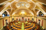 With most legislators working remotely, members present on the Minnesota House floor stood for the Pledge of Allegiance at the start of the fifth spec