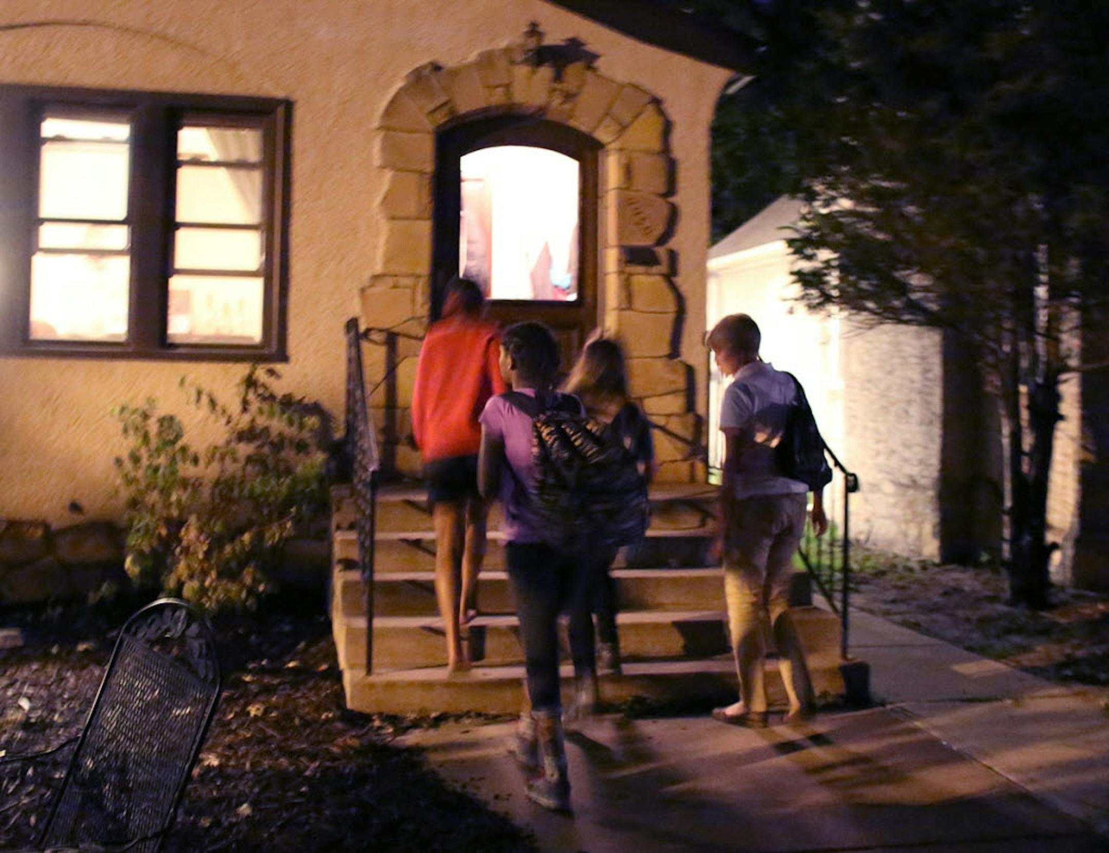 Isabel (Izzy) Marie Ward, 13, Gabriella (Gabby) Rae Woods, 12, and Keneni Mekonen Legese, 11, walked inside Ward's home with Julie Broberg, Ward's aunt, and Mariah Woods, Gabby's sister, in Minneapolis on Tuesday.