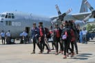 Sri Lankan students, who returned from Kathmandu after Saturday�s massive earthquake, arrive at the Air Force base in Katunayake, on the outskirts o