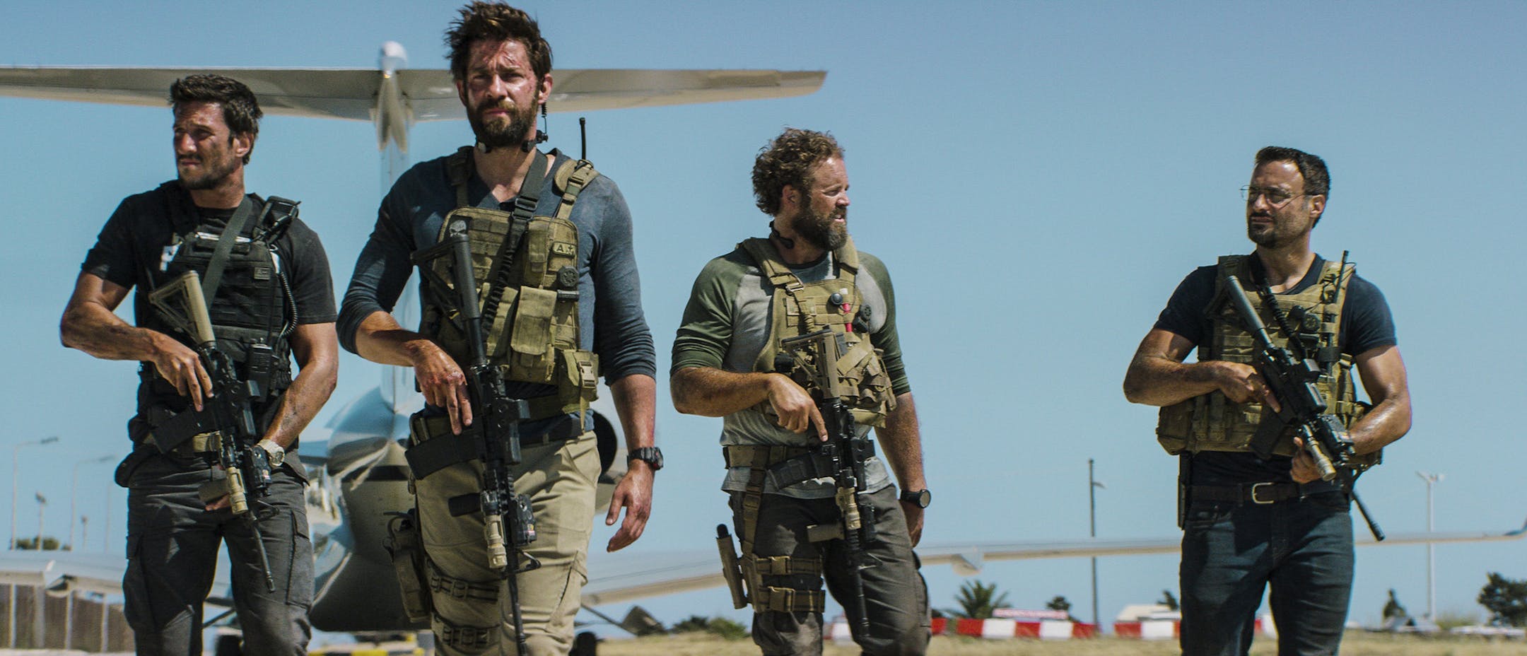In this photo provided by Paramount Pictures shows Pablo Schreiber, from left, as Kris "Tanto" Paronto, John Krasinski as Jack Silva, David Denman as Dave "Boon" Benton and Dominic Fumusa as John "Tig" Tiegen, in the film, "13 Hours: The Secret Soldiers of Benghazi" from Paramount Pictures and 3 Arts Entertainment/Bay Films. The movie releases in U.S. theaters Jan. 15, 2016. (Christian Black/Paramount Pictures via AP) ORG XMIT: MIN2016011416095748