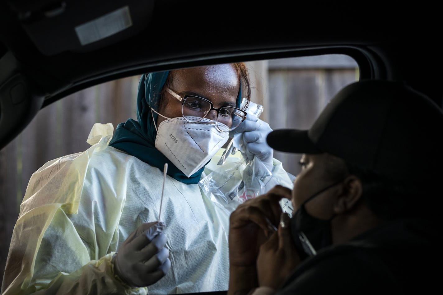 Medical assistant Samara Yusuf tested a patient in the drive-through COVID-19 testing site at North Memorial Health in Robbinsdale on Friday.