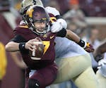 Minnesota's quarterback Mitch Leidner escaped the clutches of Purdue's defensive tackle Eddy Wilson during the fourth quarter as Minnesota took on Pur