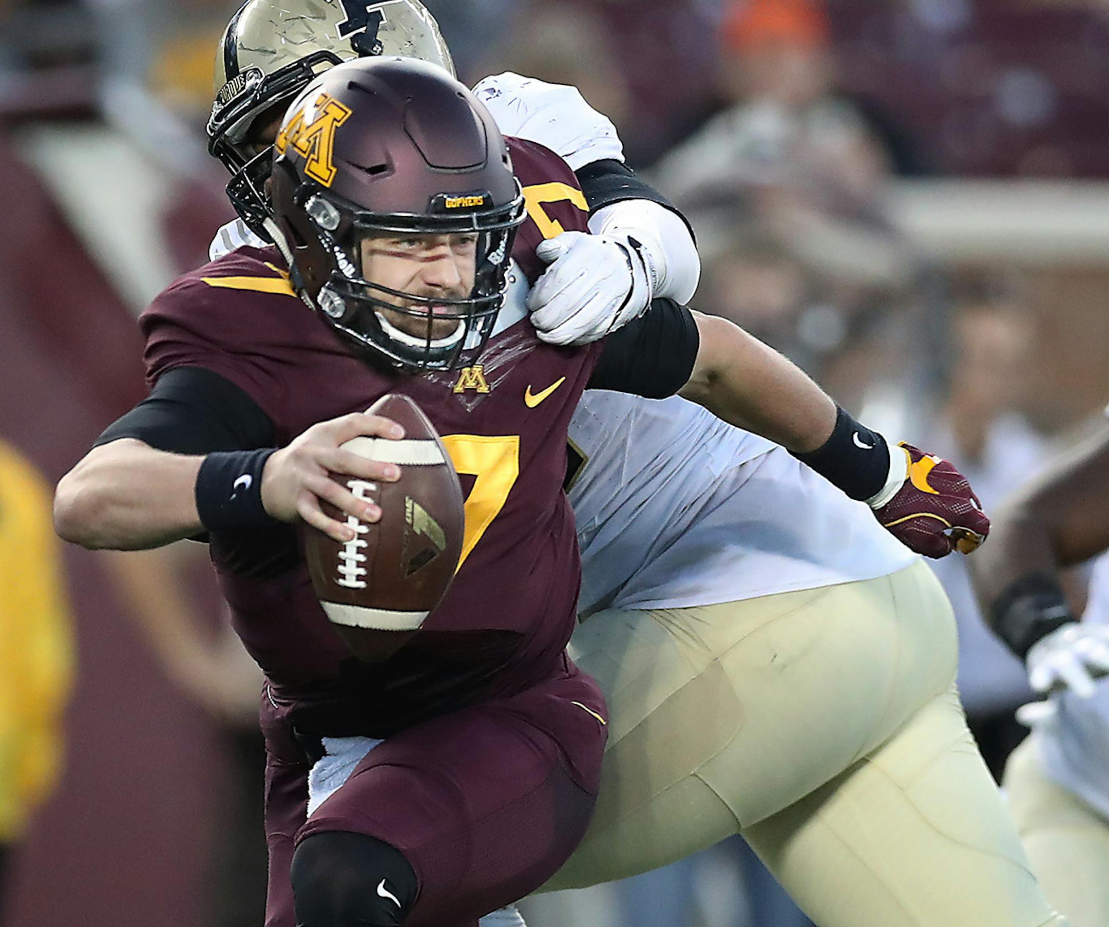 Minnesota's quarterback Mitch Leidner escaped the clutches of Purdue's defensive tackle Eddy Wilson during the fourth quarter as Minnesota took on Purdue at TCF Bank Stadium, Saturday, November 5, 2016 in Minneapolis, MN. ] (ELIZABETH FLORES/STAR TRIBUNE) ELIZABETH FLORES &#x2022; eflores@startribune.com ORG XMIT: MIN1611051849430145