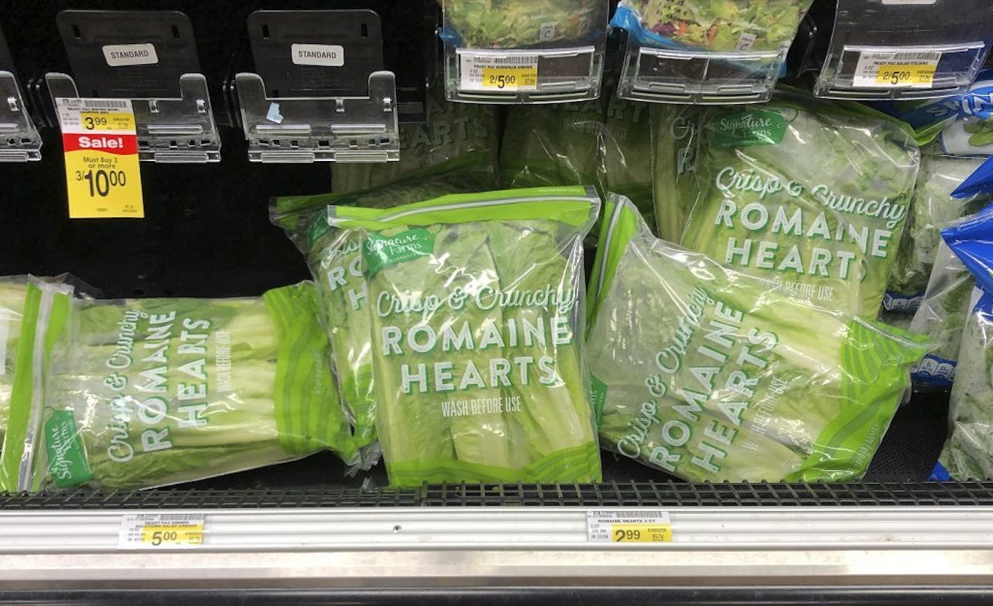 Romaine lettuce still sits on the shelves in the produce area of an Albertsons market Tuesday in Simi Valley, Calif. Health officials told people to stop eating romaine lettuce because of a new E. coli outbreak.