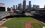 Groundskeepers worked to transform Target Field from a baseball to a football configuration in preparation for Saturday's game between St. Thomas and 