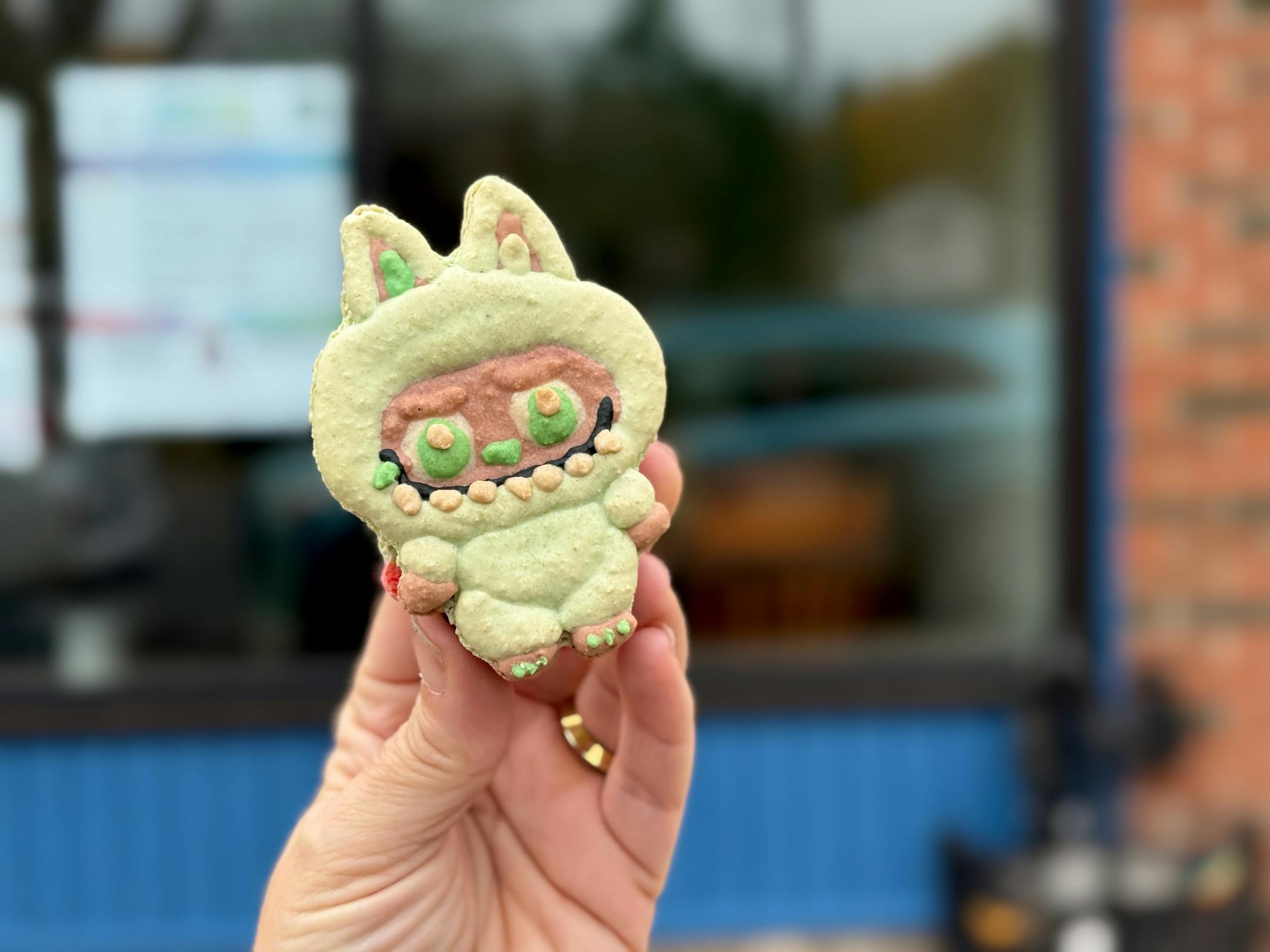 A green Labubu macaron outside X2 Pastries bakery