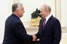 Russian President Vladimir Putin, right, and Hungarian Prime Minister Viktor Orban shake hands during a meeting in Moscow, Russia, Friday, July 5, 202