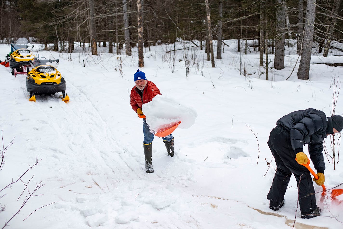 (Left) Mark Helmer and his fellow groomer, Craig Brown, shoveled snow to reinforce an icy patch of the ski trail on Friday January 3, 2020. ] ALEX KORMANN • alex.kormann@startribune.com The Korkki Nordic Center in Duluth, MN is a hidden gem of Nordic ski trails that was previous only open to professional racers before it was opened to the public in 1980. While not being a widely known trail, Korkki has a loyal community of local skiers that have been skiing on the trail for years.