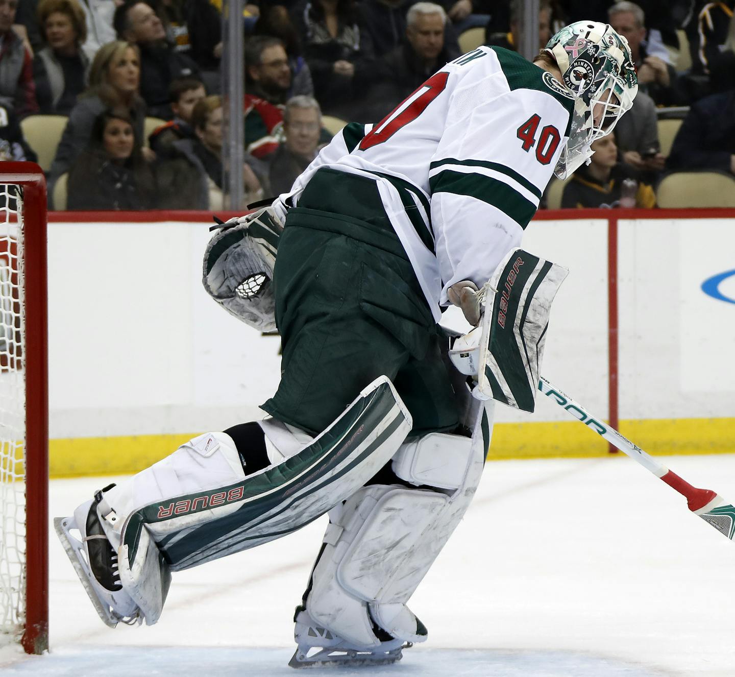 Minnesota Wild goaltender Devan Dubnyk skates to his bench after being pulled for goalie Alex Stalock after allowing the fourth goal of the game to Pittsburgh Penguins' Brian Dumoulin during the second period of an NHL hockey game in Pittsburgh, Thursday, Jan. 25, 2018. (AP Photo/Gene J. Puskar)