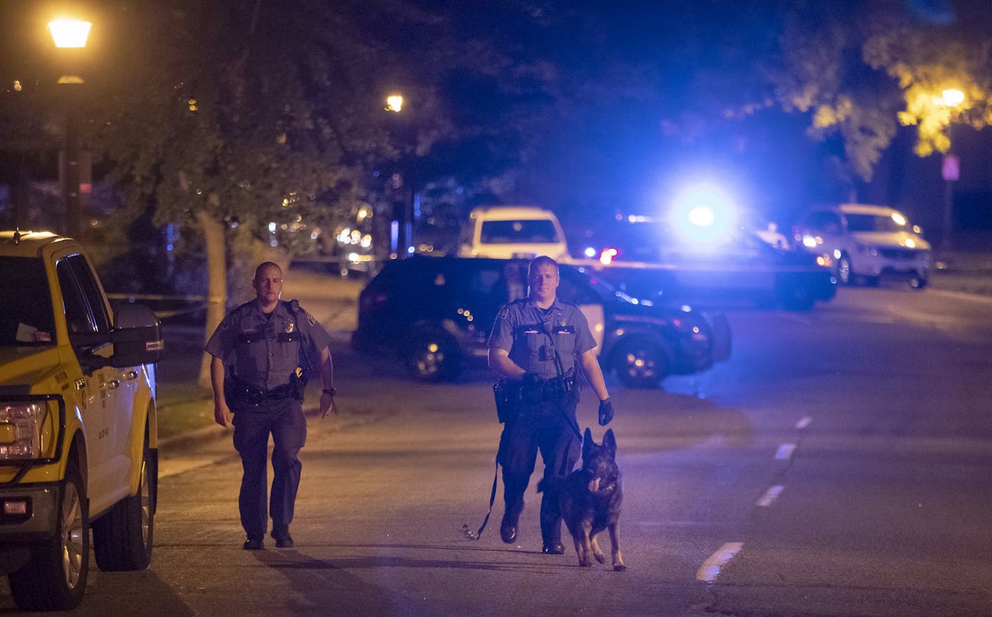 Police investigated the scene where one person and a child were found with gunshot wounds after a vehicle rollover, Sunday, October 6, 2019 in St. Paul, MN.