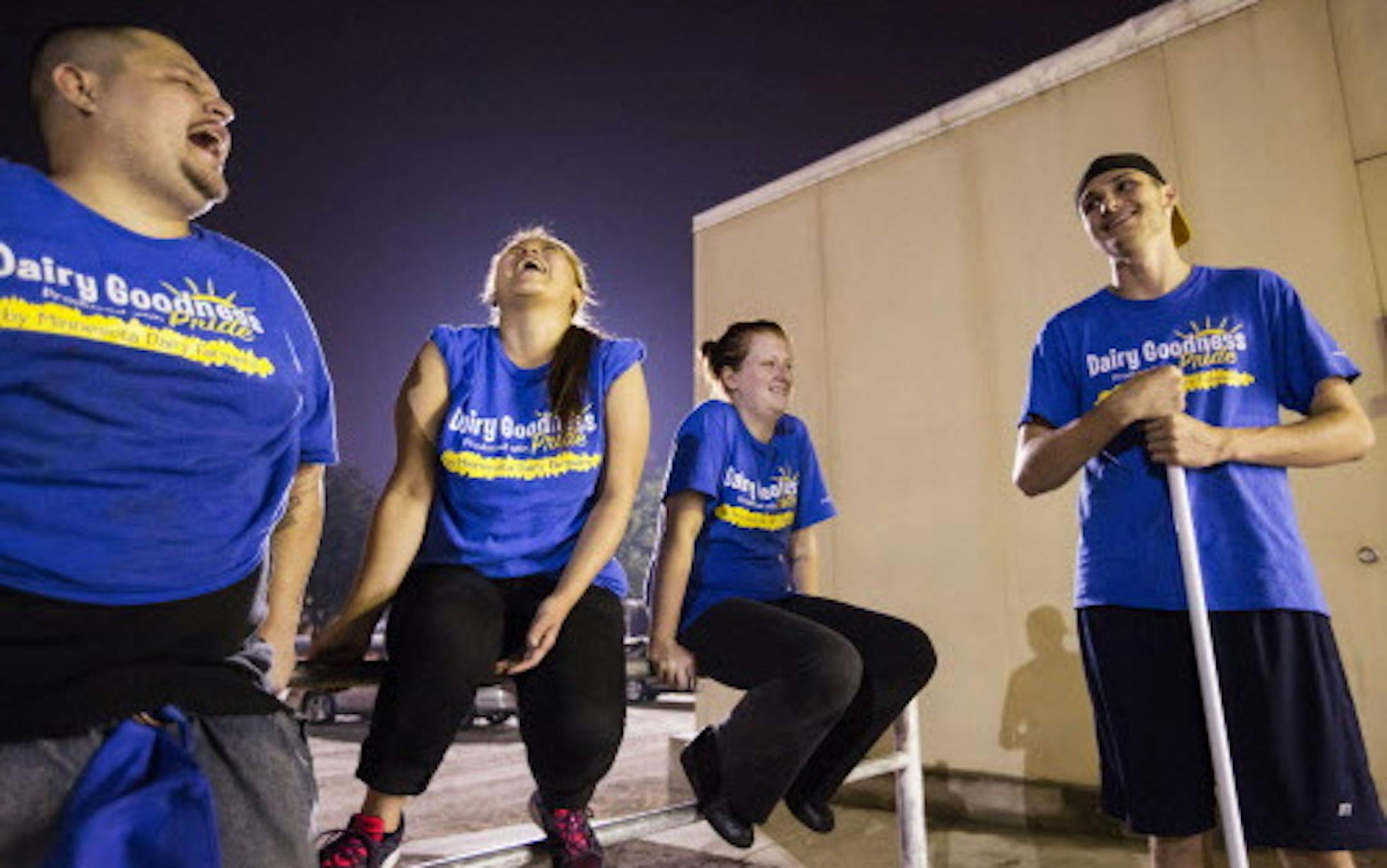 Night shift workers laugh and chat after their job cleaning the Dairy Goodness booth inside the Dairy Barn is complete at the Minnesota State Fair early in the morning on Tuesday, September 1, 2015. From left is Steven Sevilla, Anna Thao, Alicia Schulte and Nick Vanek. ] LEILA NAVIDI leila.navidi@startribune.com /