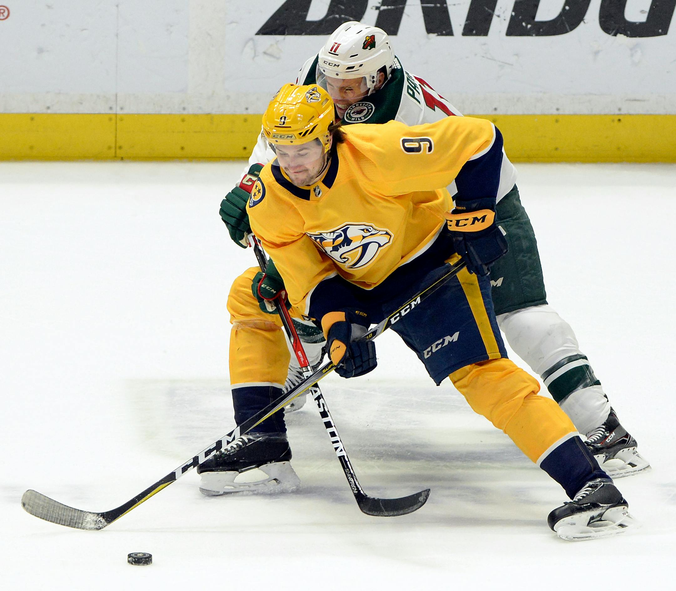 Nashville Predators left wing Filip Forsberg (9), of Sweden, battles Minnesota Wild left wing Zach Parise (11) for the puck during the first period of an NHL hockey game Tuesday, March 27, 2018, in Nashville, Tenn. (AP Photo/Mark Zaleski)