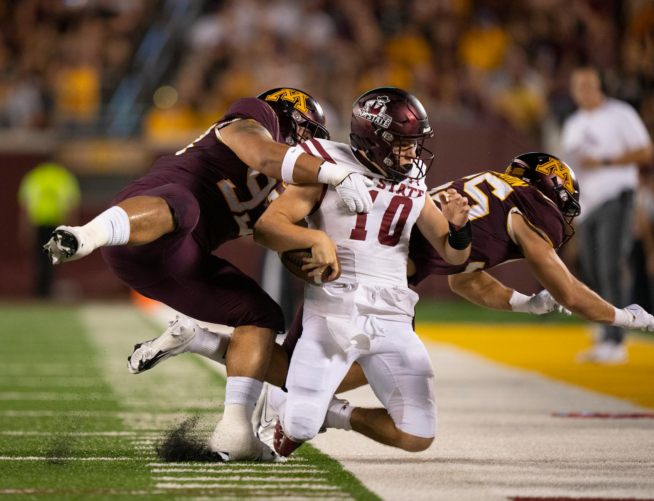 Minnesota Golden Gophers defensive lineman Kyler Baugh (93) and linebacker Mariano Sori-Marin (55) forced New Mexico State Aggies quarterback Diego Pavia (10) out of bounds in the first quarter.