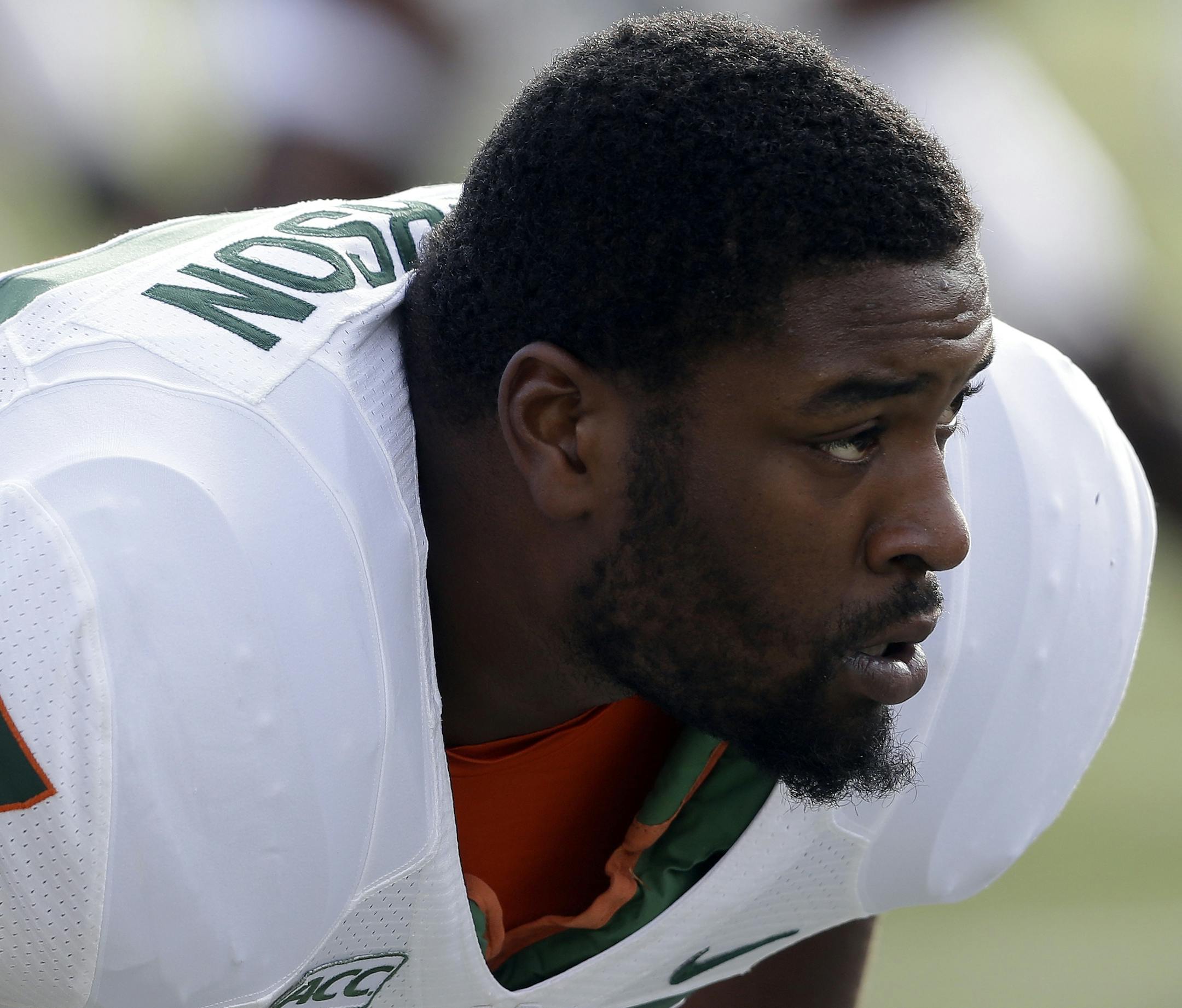 Miami's Seantrel Henderson (77) stretches during pre-game warmups prior to an NCAA college football game against Duke in Durham, N.C., Saturday, Nov. 16, 2013. (AP Photo/Gerry Broome) ORG XMIT: OTK107.JPG