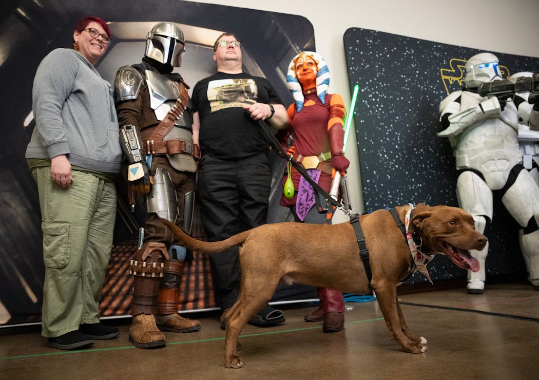 Jodi and Keith Rose and their dog Whiskey pose for a photo with characters at a Star Wars Party for Charity at Nine Mile Brewing in Bloomington on Saturday, a k a May the Fourth. 