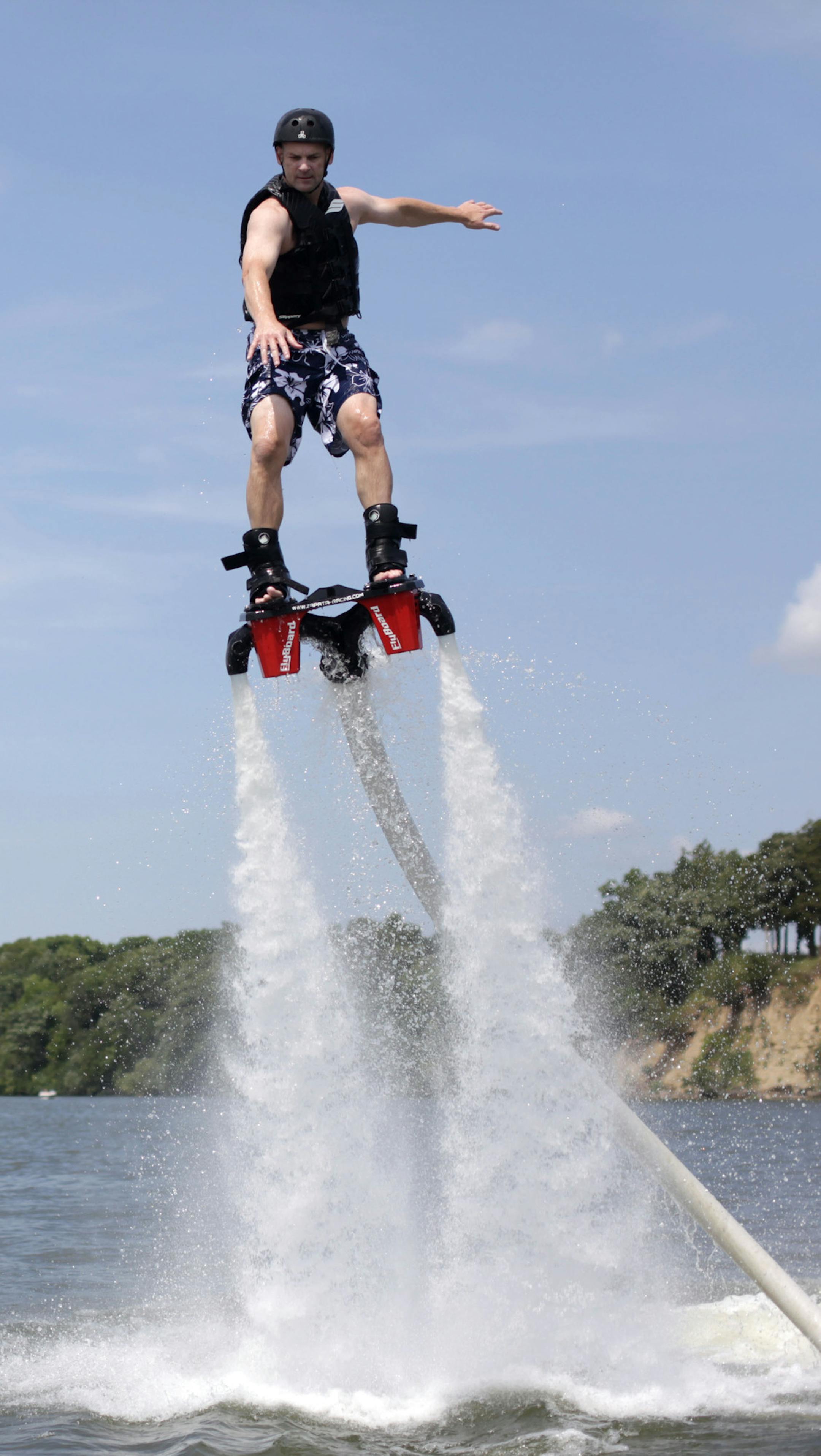 Matt Hawkins of St. Louis Park, takes flyboarding lessons from Rodney Jansen on Friday afternoon at Lake Waconia.] Rodney Jansen gave flyboarding lessons on Lake Waconia on Friday afternoon. Jansen started flyboarding three years ago, and started his rental company two years ago. His last weeks of summer will be busy as he is booked through the end of the season. MONICA HERNDON Waconia, MN 08/15/14
