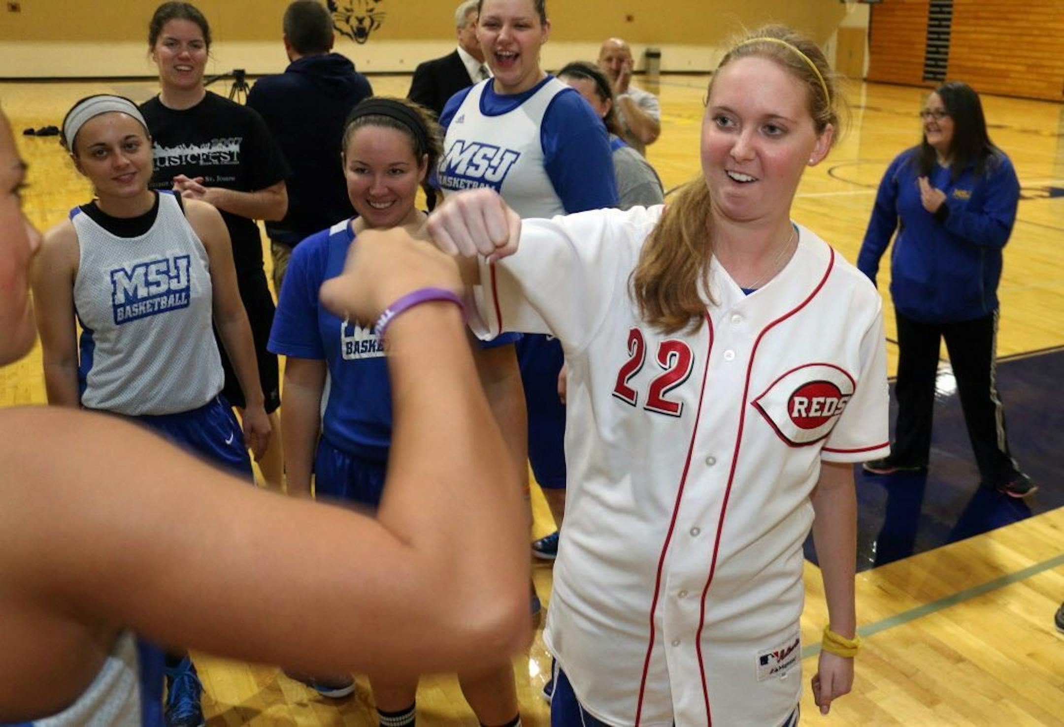 Lauren Hill gets congratulation from a teammate after practicing with her NCAA college basketball team at Mount St. Joseph University in Cincinnati on Thursday, Oct. 23, 2014.