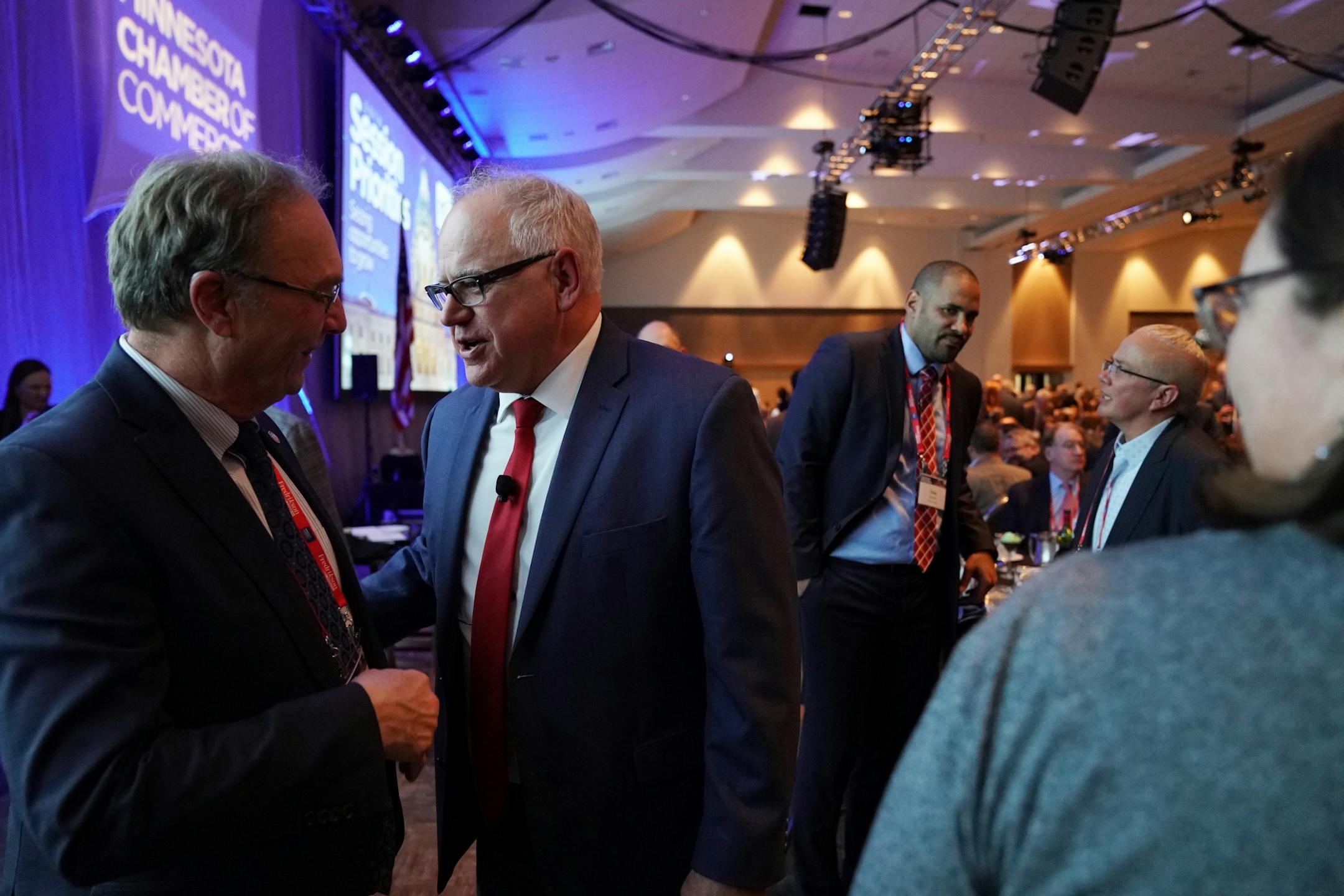 Gov. Tim Walz spoke with Rep. Paul Torkelson during the Minnesota Chamber of Commerce's annual policy kickoff event Wednesday.