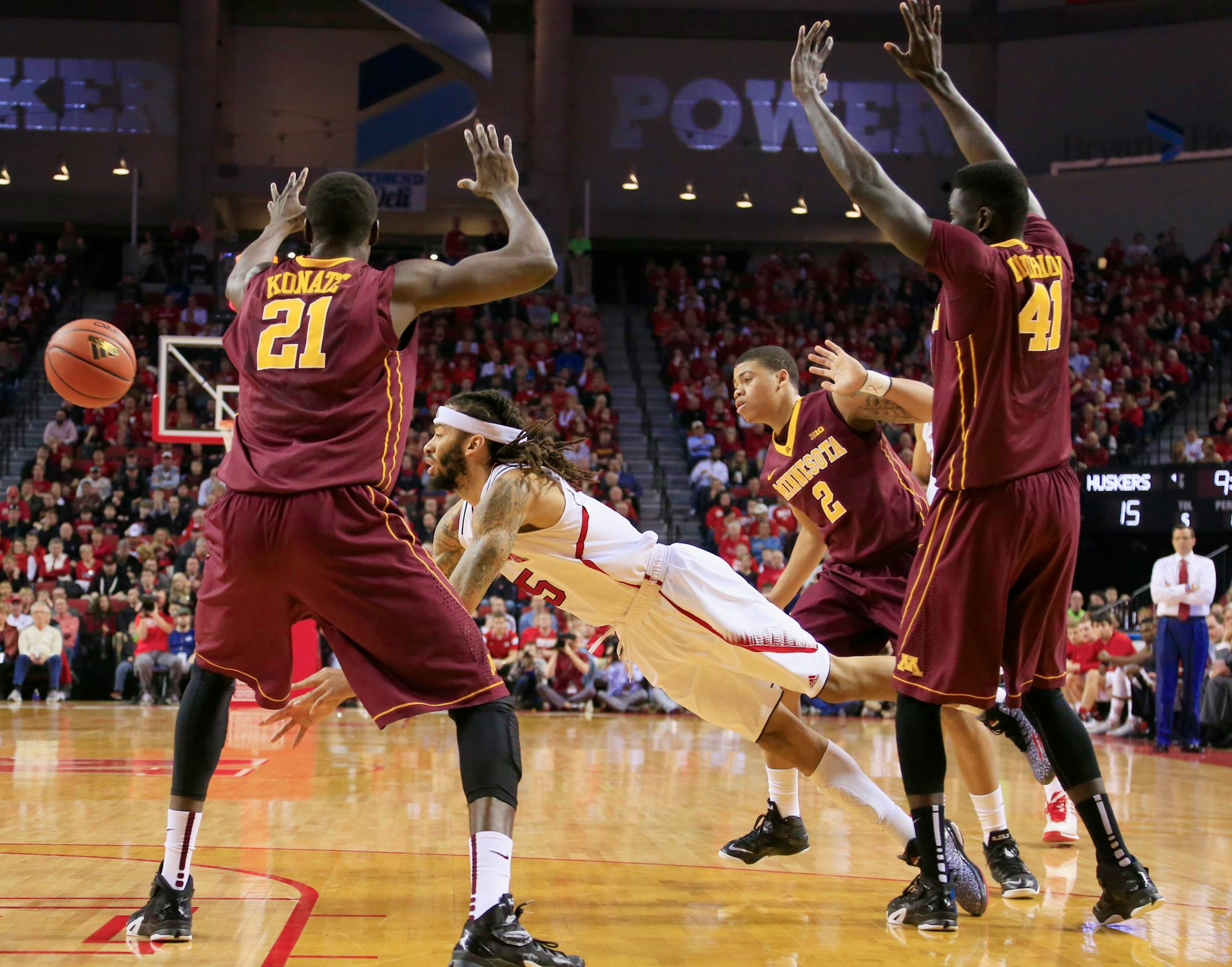 Nebraska's Terran Petteway (5) is surrounded by Minnesota's Bakary Konate (21), Gaston Diedhiou (41) and Nate Mason (2) during the first half of an NCAA college basketball game in Lincoln, Neb., Tuesday, Jan. 20, 2015. (AP Photo/Nati Harnik)