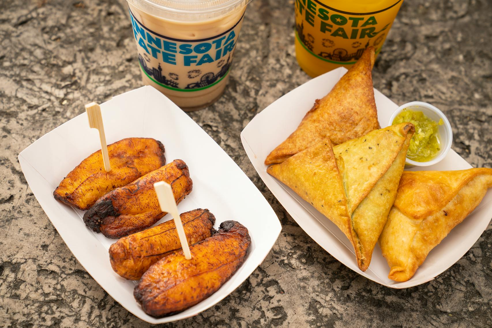 Foods from new vendor Afro Deli: Sambusas, Sweet Plantains, Somali Tea and Fresh Mango Juice. The new foods of the 2023 Minnesota State Fair photographed on the first day of the fair in Falcon Heights, Minn. on Tuesday, Aug. 8, 2023. ] LEILA NAVIDI • leila.navidi@startribune.com