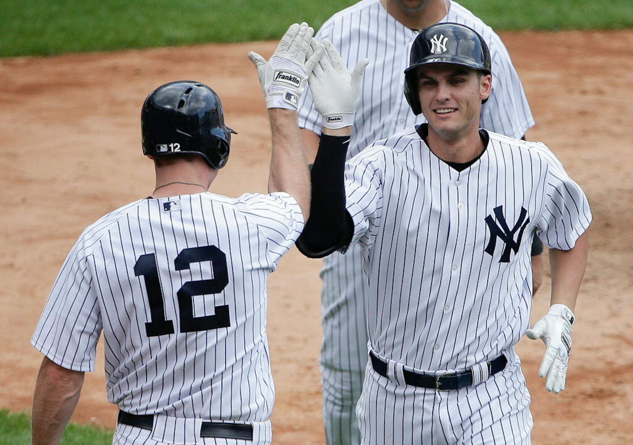 New York Yankees' Greg Bird, right, is greeted by Chase Headley (12) after hitting a two-run home run against the Minnesota Twins during the sixth inning of a baseball game, Wednesday, Aug. 19, 2015, in New York. It was his second two-run home run of the game and second career major league home run.
