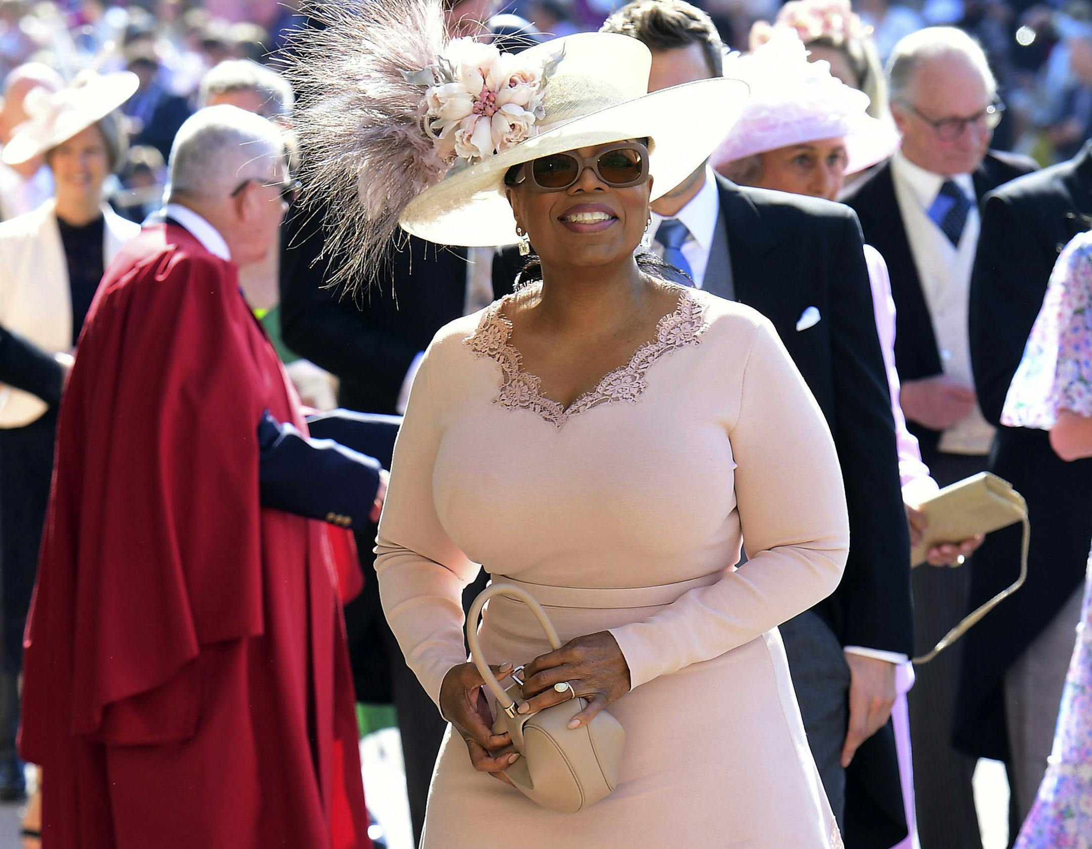 Oprah Winfrey smiles as she arrives at St George's Chapel at Windsor Castle the wedding ceremony of Prince Harry and Meghan Markle at St. George's Chapel in Windsor Castle in Windsor, near London, England, Saturday, May 19, 2018. (Ian West/pool photo via AP)