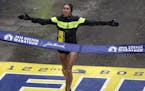FILE- In this April 16, 2018, file photo, Desiree Linden, of Washington, Mich., crosses the finish line to win the women's division of the 122nd Bosto