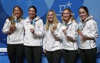 United States' Meghan Duggan, from left, Hilary Knight, Monique Lamoureux-Morando, Jocelyne Lamoureux-Davidson and Maddie Rooney pose for photos with 
