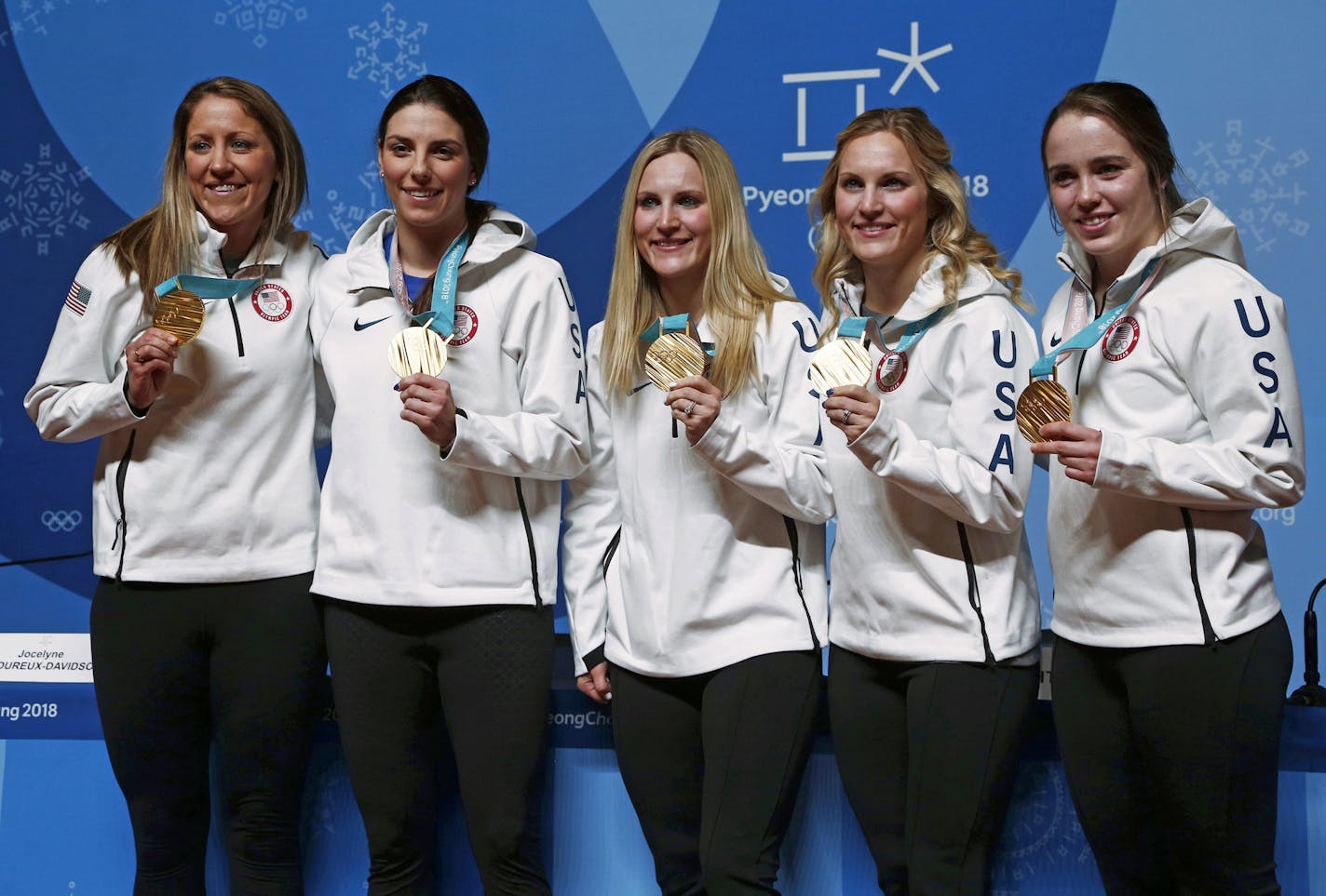 United States' Meghan Duggan, from left, Hilary Knight, Monique Lamoureux-Morando, Jocelyne Lamoureux-Davidson and Maddie Rooney pose for photos with their gold medal in women's hockey at a news conference at the 2018 Winter Olympics in Pyeongchang, South Korea, Friday, Feb. 23, 2018. Twenty years after taking gold when the sport was added to the Olympics, the United States snapped Canada's streak of four straight golds on Thursday. (AP Photo/Peter Morgan)