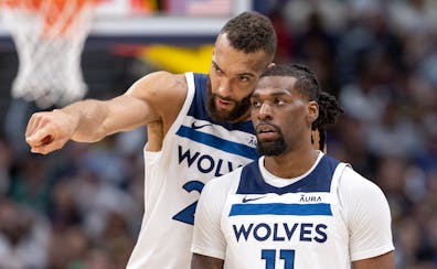 Rudy Gobert and Naz Reid (11) of the Timberwolves talked during the third quarter of their victory over the Nuggets on Saturday night in Denver.