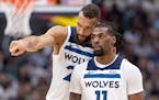 Rudy Gobert and Naz Reid (11) of the Timberwolves talked during the third quarter of their victory over the Nuggets on Saturday night in Denver.