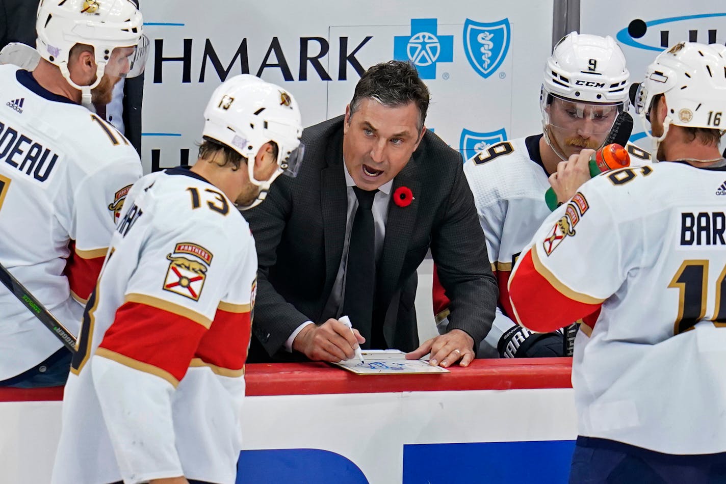 Florida Panthers interim coach Andrew Brunette, center, gives instructions during overtime of the team's NHL hockey game against the Pittsburgh Penguins in Pittsburgh, Thursday, Nov. 11, 2021. The Penguins won in a shootout, 3-2. (AP Photo/Gene J. Puskar)