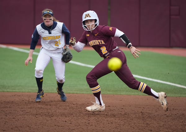 Minnesota infielder Sydney Strelow (2) darts toward second base as a ground ball hit by infielder Maddy Ehlke (17) is in play in the second inning aga