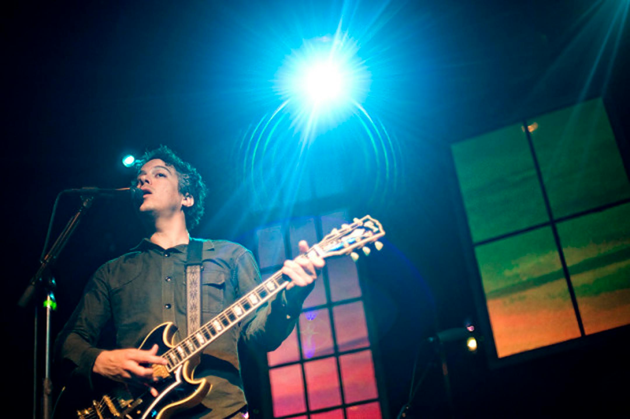 M. Ward's window backdrop changed from sunset to sunrise throughout his 90-minute set at First Ave on Thursday. / Photos by Leslie Plesser