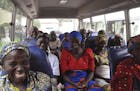 Family members of the Nigerian Chibok kidnapped girls share a moment as they depart to the Nigerian minister of women affairs in Abuja, Nigeria, Tuesd