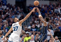 Rudy Gobert (27) of the Minnesota Timberwolves and Kyrie Irving (11) of the Dallas Mavericks during Game 3 of the NBA Western Conference finals at Ame