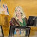 Stormy Daniels testifies on the witness stand as a promotional image for one of her shows featuring an image of Trump is displayed on monitors in Manh