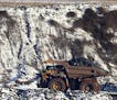 A view of Hull Rust Mine: the world's largest open pit mine, where a giant truck is seen carrying iron ore rocks Tuesday, Nov. 24, 2015, in Hibbing, M
