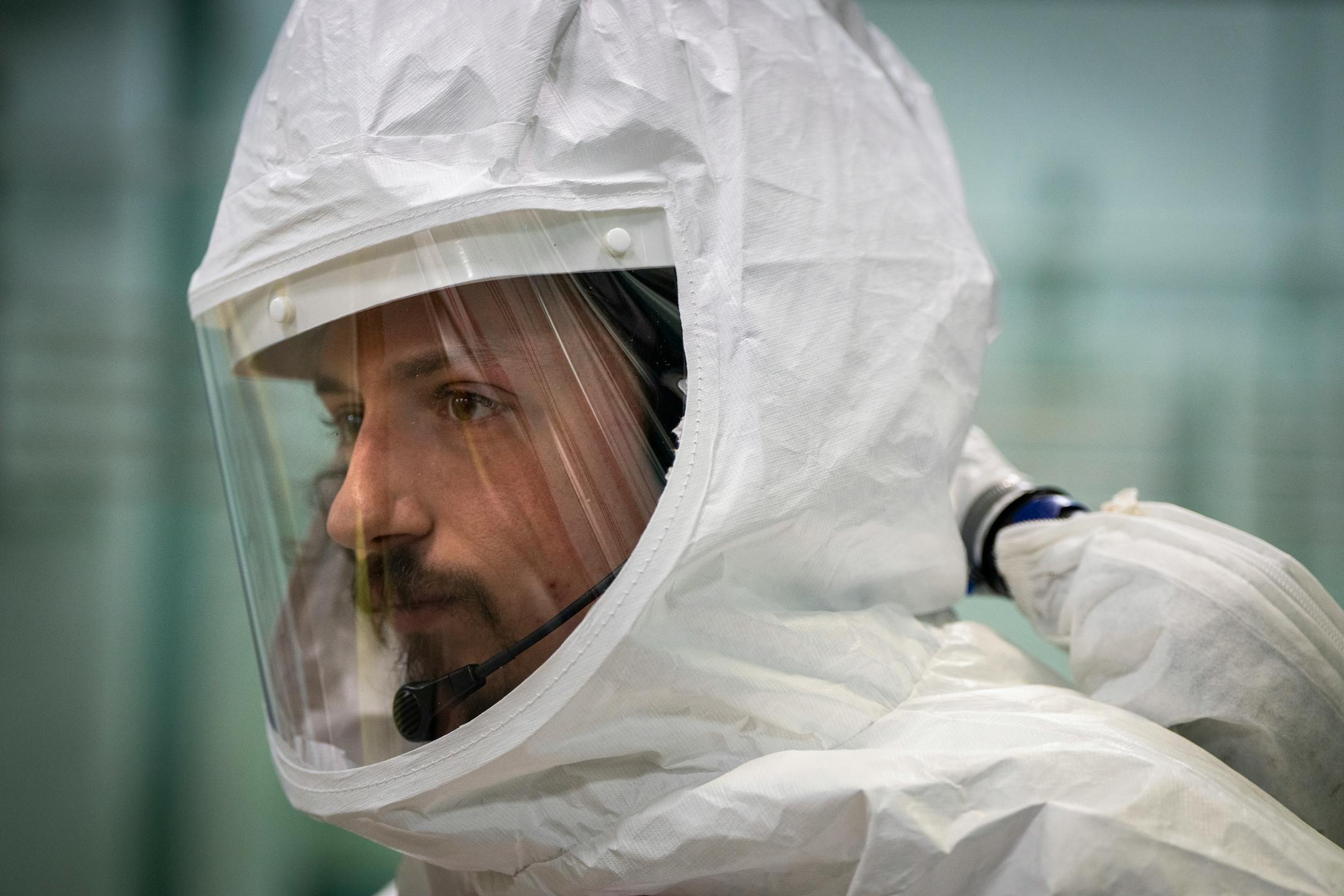 Under-vessel technician Matt Nelson suits up with protective layers before working on control rod drive replacement inside the reactor building.