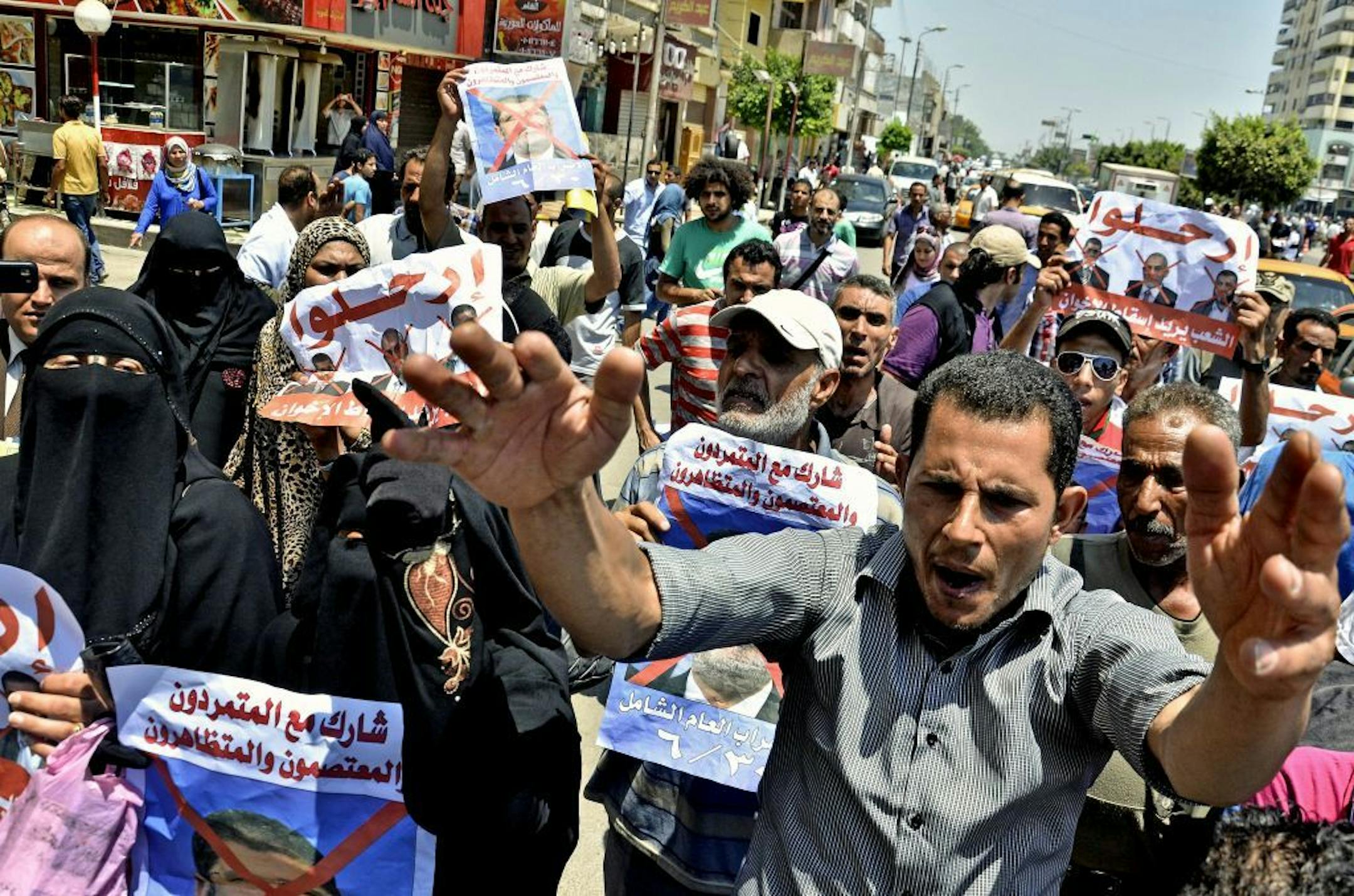 Protesters chant slogans against Egyptian President Mohammed Morsi outside a court in Ismailia, 139 Kilometers (86 miles) from Cairo, Egypt, Sunday, June 23, 2013.